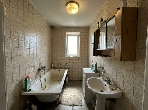 A bathroom in an apartment building before renovation—illustration