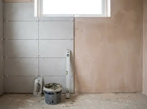 A bathroom wall while the tiles are being laid—illustration